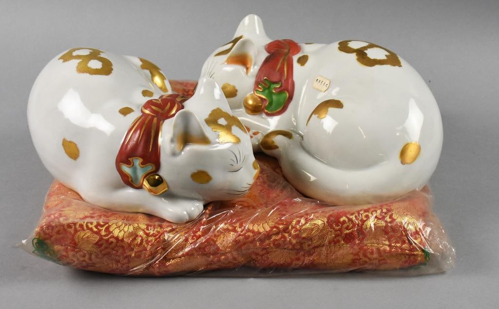 Kutani Japanese Porcelain Kitty Cats on Pillow: Adorable sleeping Kutani kitties in porelain. They are Japanese in origin and appear hand painted. Each with red, green and gold retaining the original paper label. They come on a red and gold brocade