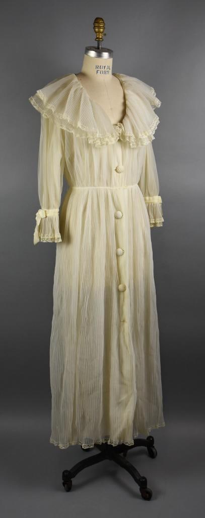 c1990 Christian Dior Off White Ruffle Collar Dress: Such a pretty vintage dress from Christian Dior. Off white pleated nylon with double ruffle collar with lace trim, gathered waist and double lace trimmed ruffle sleeve with ribbon. Cloth covered butto