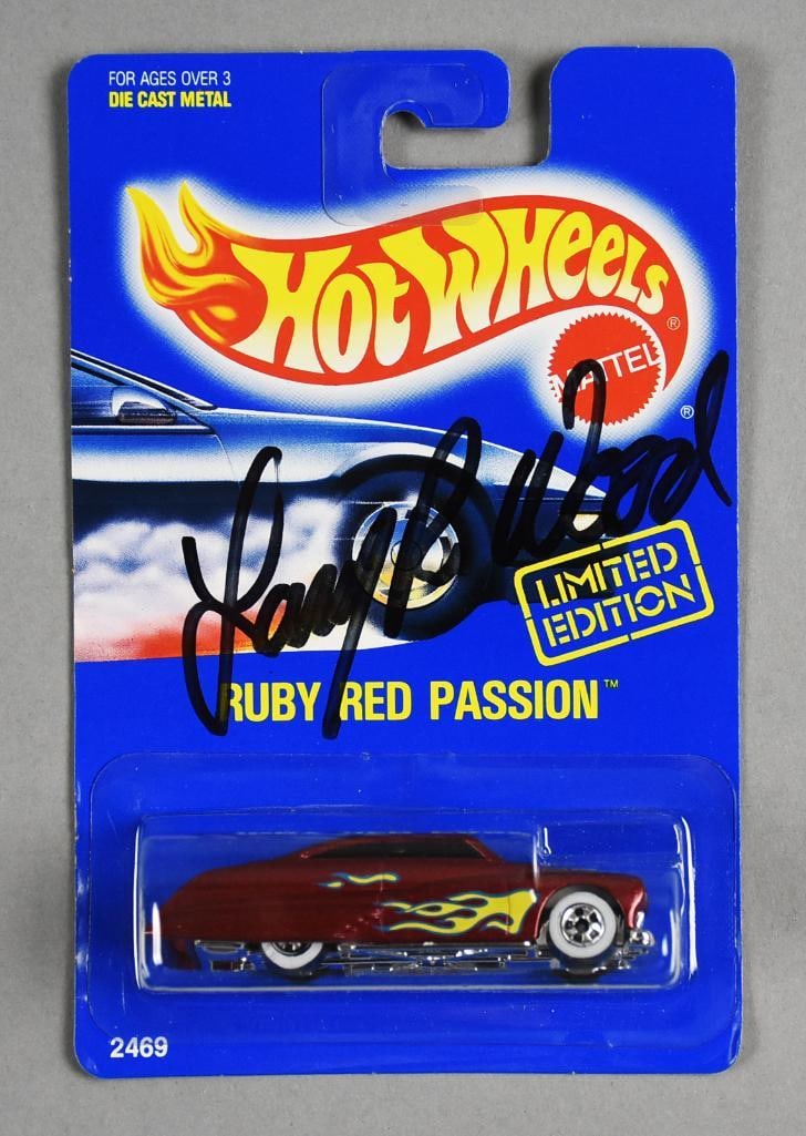 1991 Larry Wood Signed Mattel Hot Wheels Ruby Red Passion-NOS: Brand & Model: 1991 Mattel Hot Wheels "Ruby Red Passion" – Signed by Larry Wood Scale: 1:64 Material: Diecast Metal with Plastic Components