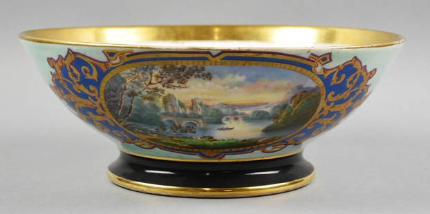 Antique French Porcelain Hand Painted Centerpiece Bowl: This stunning bowl appears to be of French origin. Each side of the bowl has a wonderful hand painted landscape with boat on the water and a home backed with trees on one side and a waterway with a sm
