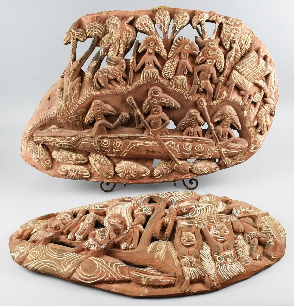 2 New Guinea Hand Carved Storyboards: Wonderful lot of 2 hand carved wood Papua New Guinea storyboards. Both depict men in boats going by and greeting the villagers while fish swim underneath their canoes. Longest length measures 28" and 