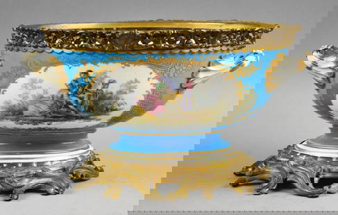 Antique Sevres Style Centerpiece Porcelain & Ormolu Bowl: This gorgeous bowl is in Sevres style. Porcelain with hand painted courting scenes on both sides with heavy gold accents. Each handle with leaf motif and appear to be all part of the bowl, not