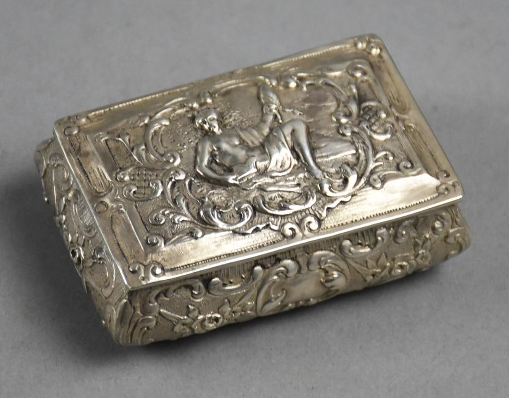 Victorian Sterling Silver Repousse Trinket Box: This stunning trinket box is sterling. The repousse detail is a nude lounging woman draped in cloth with roses and C scrolls. The bottom is marked and heavily worn. Measures approx. 1" x 2" x 3" with 