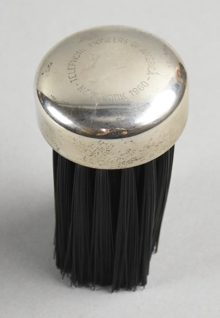 Vintage Gorham Sterling Telephone Pioneers of America Brush: This cute brush is from Gorham and is sterling with black hard bristles. The brush in engraved Telephone Pioneers of America, New York 1960. Great mid century modern piece. It is believed to be used f