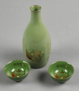 WWII Era Japanese Celadon Saki Bottle w/ Cups: Very nice looking c1940 Japanese Military saki bottle with two cups. Each is celadon piece is hand decorated with the bottle with flag and horse in a lotus design. The cups are two flags with flower a