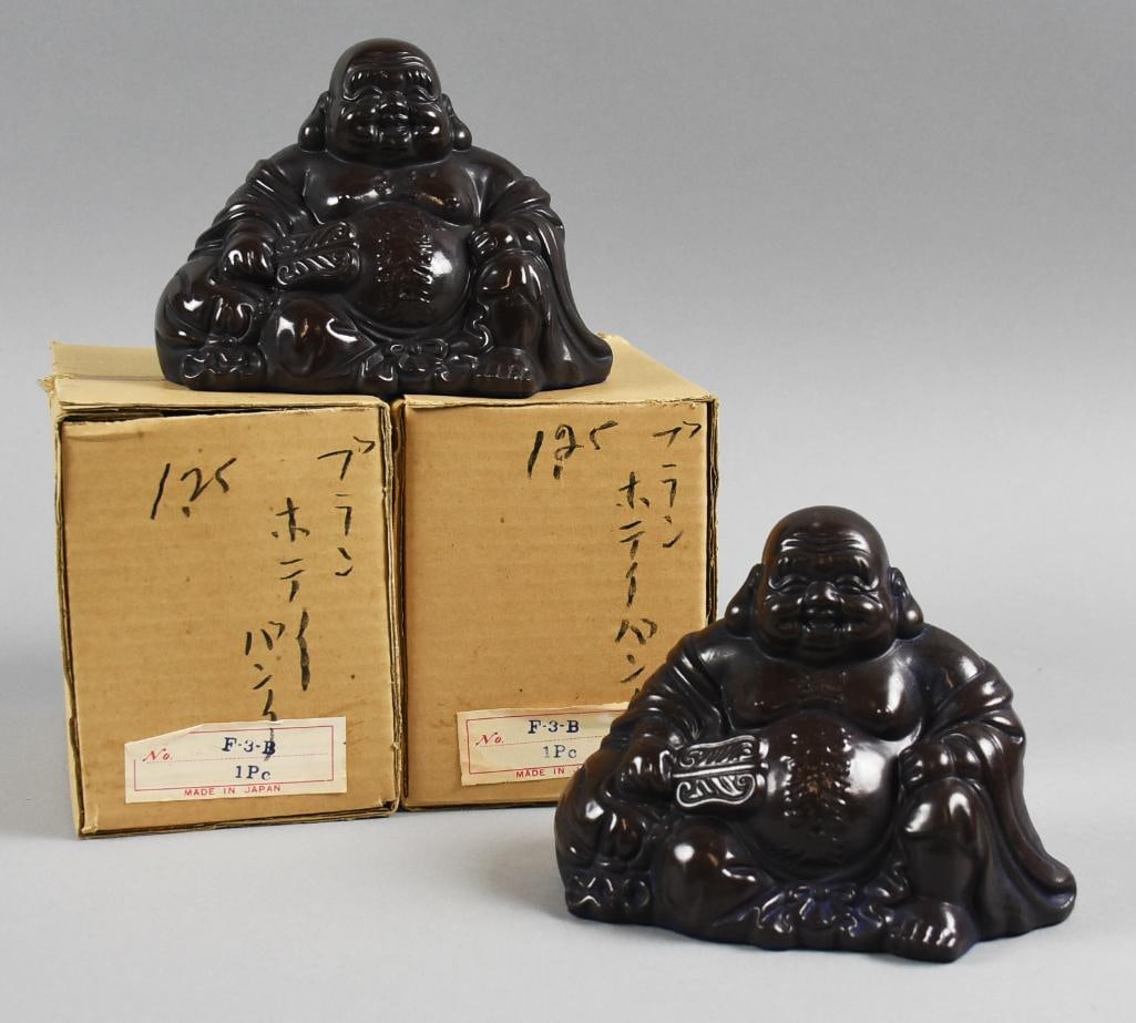 Vintage Imperial Imports Japan Cast Metal Hotei Sulptures: Adorable pair of Hotei that appear to be cast iron. Each is seated, smiling with a fan in his had. Both retain their original labels for Imperial Imports and will come in their original factory boxes.