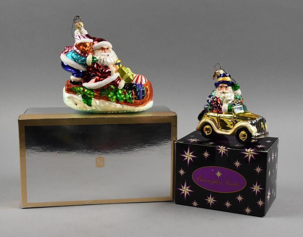 Christopher Radko Blown Glass Santa Ornaments: Darling pair of blown glass Christmas ornaments from Christopher Radko. Each is a depiction of Santa Claus with one riding in a sleigh full of gifts and comes in a Nordstrom's box and one Santa in a c