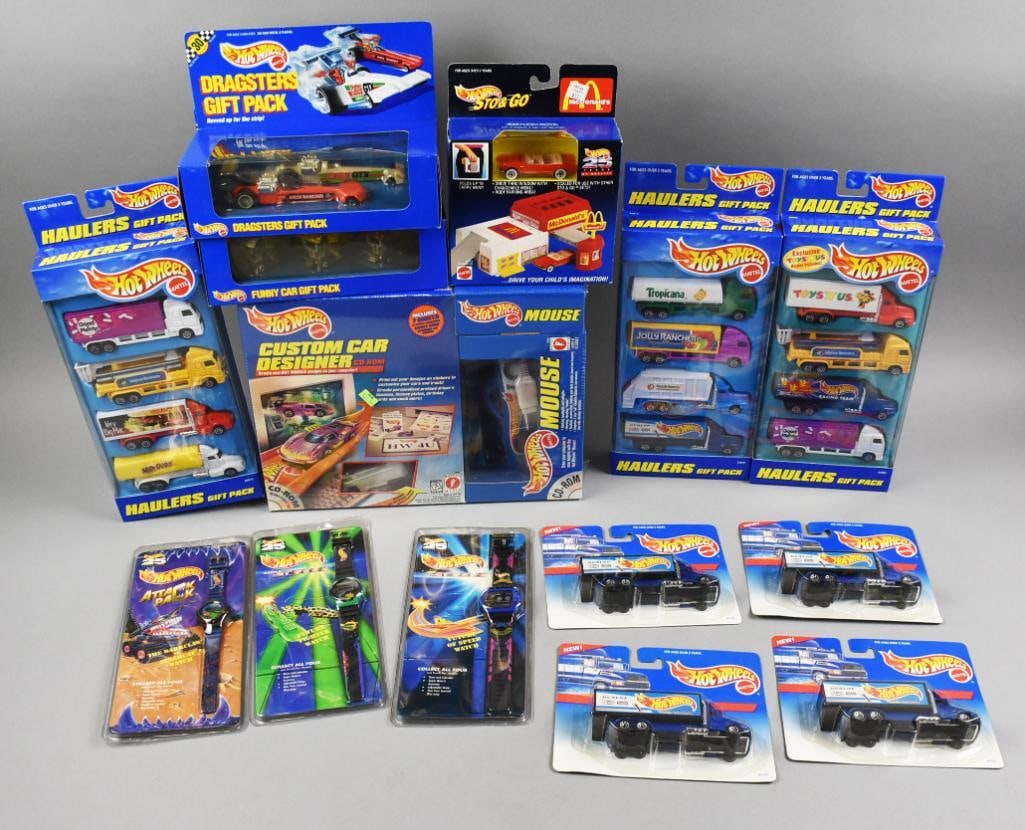 1990s Mattel Hot Wheels Gift Packs/Play Sets/PLUS-MIP-NOS: Lot is an assortment of 1990s Mattel Hot Wheels Gift Packs/Play Sets/PLUS-MIP-NOS. Includes Haulers, Sto & Go, Mouse, Custom Car Designer, Dragsters Gift Pack, Funny Car Gift Pack, four Dunlop?semi an