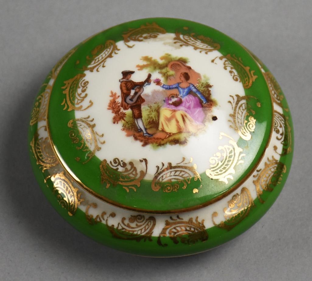 c1910 French Limoges La Seynie Porcelain Powder Jar: Beautiful antique Limoges porcelain powder jar. Hand painted courting scene with a man playing guitar to a young lady. Green glaze with hand painted gold gilt accents. Marked on the bottom Limoges ove