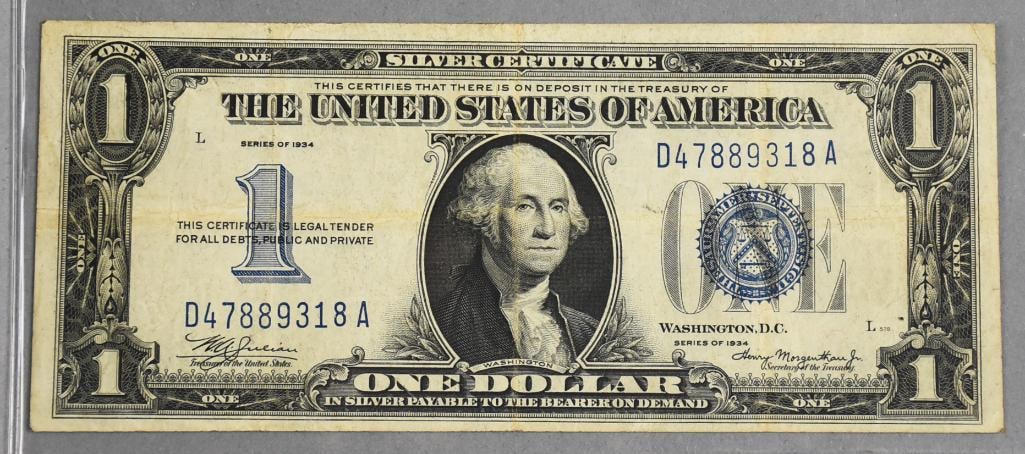 1934 $1 One Dollar Silver Certificate-Inverted Back Error: A 1935 United States one-dollar silver certificate featuring an inverted back error. The front shows a traditional blue seal and serial numbers aligned with its issue. The reverse print is upside down