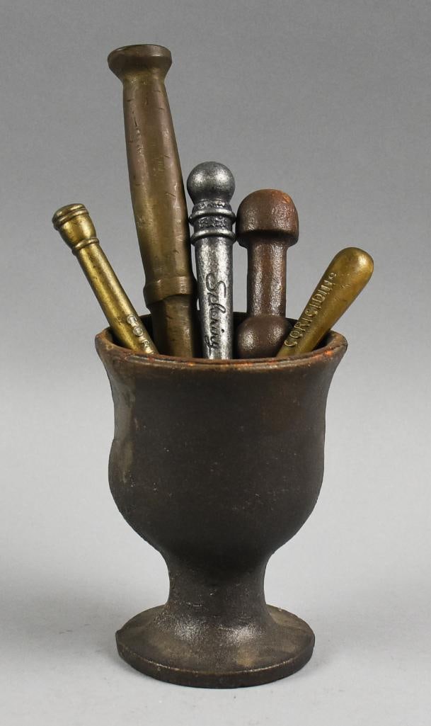 Antique Apothecary Mortar w/ Extra Pestles: This is a great lot for an iron apothecary mortar and five extra pestles. One is from Schering, a former German pharmaceutical company, two are from Coricidn and two are unmarked. Mortar measures appr