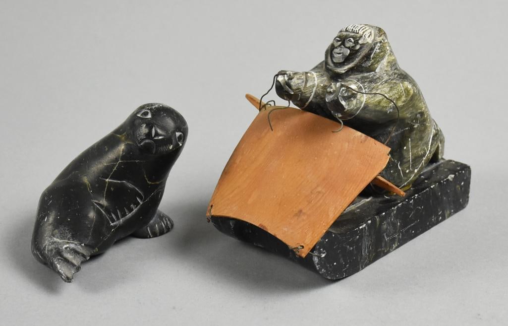 Arnold Kayutak and Jeremiah Echalook Inuit Carved Figures: Darling pair of vintage Inuit figures, both signed by artist. The first one is a baby seal signed and numbered by artist Jeremiah Echalook. The second one is a sledder with what appears to be teak, si