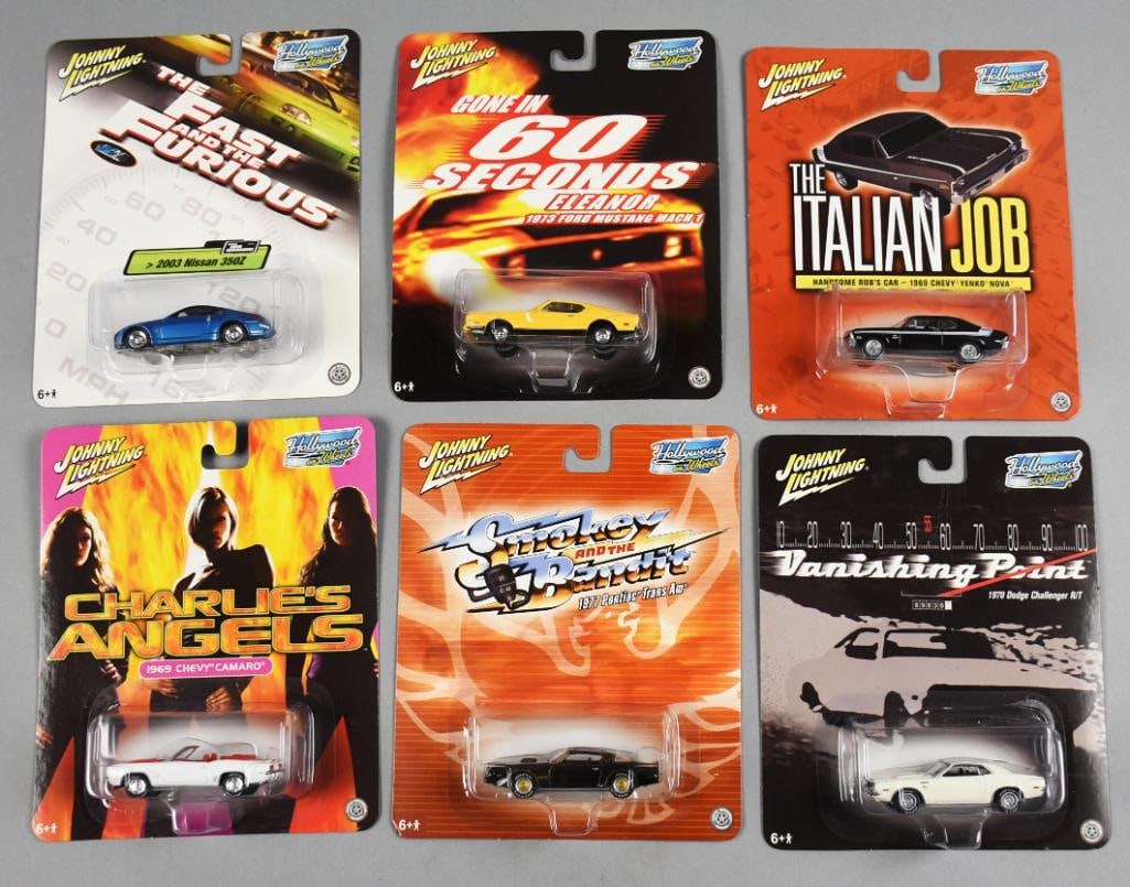 (6) 2004 Johnny Lightning Hollywood on Wheels MOC NOS: Six Johnny Lightning Hollywood on Wheels die-cast cars still in original packaging. Includes replicas of vehicles from iconic movies: 'Fast & Furious,' 'Gone in 60 Seconds,' 'The Italian Job,' 'Charli