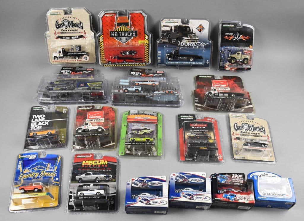 (18) 2000s Greenlight Die-Cast Assortment MOC-NOS: Lot is 18 2000s Greenlight Die-Cast Assortment - MOC-NOS. Includes: 1/64 scale die-cast vehicles from GreenLight, featuring various themed series such as Gas Monkey Garage, Mecum Auctions, Verizon Ind