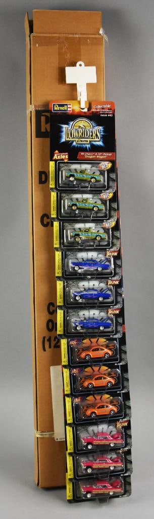 2000 Revell Clip Strip Store Display Cars Factory Shipping Box: Lot is a 2000 Revell Low Rider Die-Cast on Clip Strip Store Display-MIP-NOS. Comes in the original manufacturer shipping box. Includes 12 cars, four of each style. Single owner collection from the lar