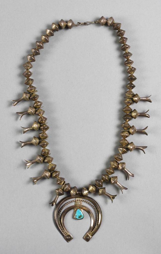 Vintage Navajo Sterling & Turquoise Squash Blossom: Gorgeous vintage piece is Navajo. Sterling squash blossom necklace with squash and blossom beads and a sterling naja with a treated turquoise stone. Measures approx. 20" long, naja being approx. 3" x 