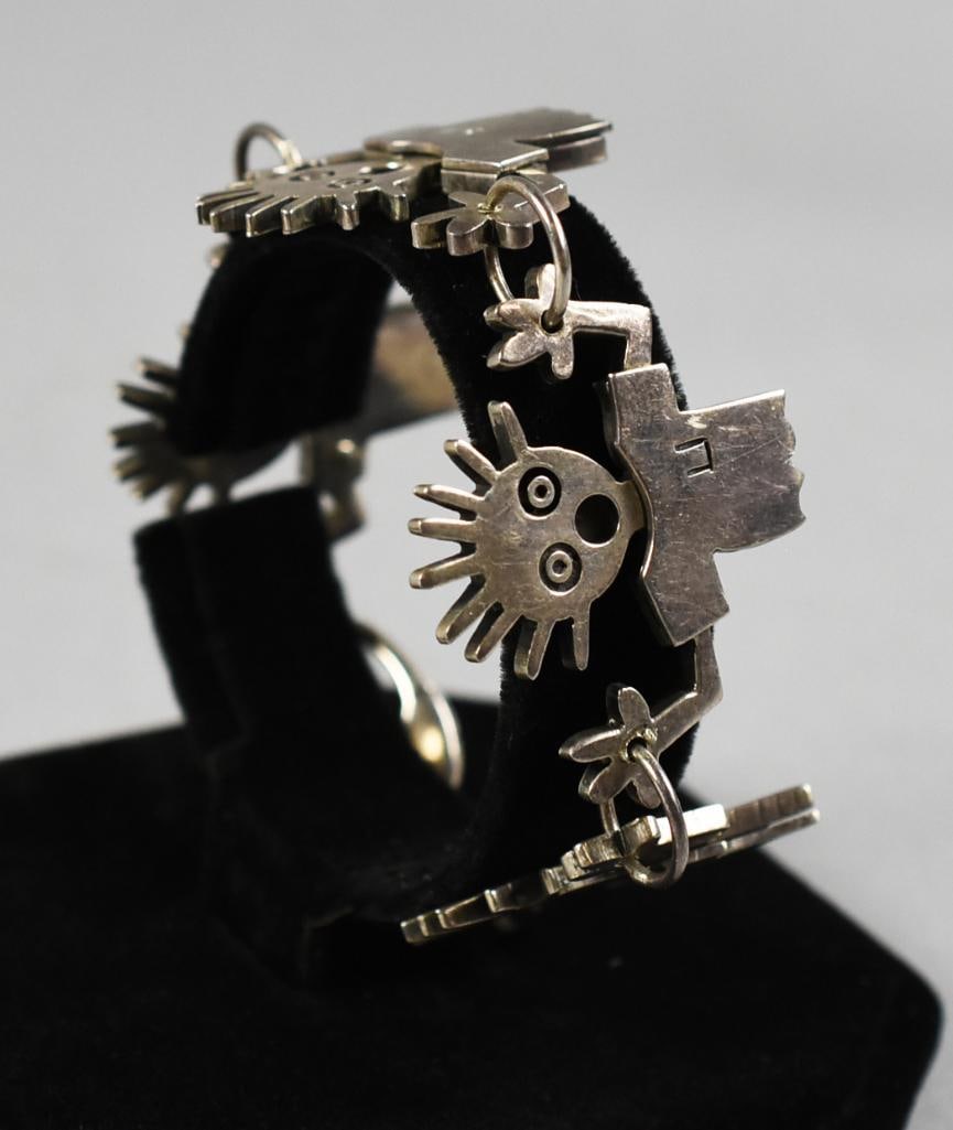 Katie Freedman Attrib Scared Child Sterling Bracelet: Sterling bracelet attributed to jewelry artist Katie Freedman. Four scared guys wearing t-shirts with their hands up and lobster claw closure. Stamped sterling and 925 on the clasp. Note that not all 