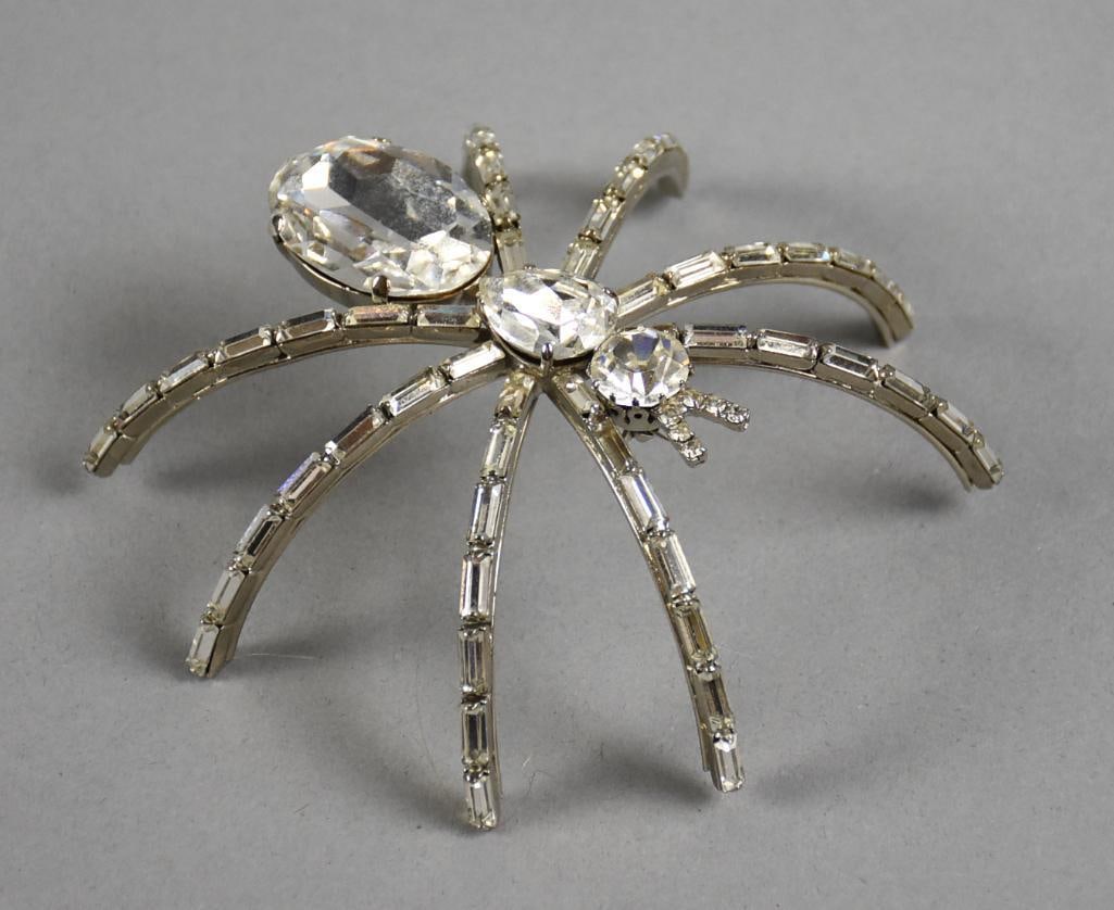 c1980 Butler & Wilson Rhinestone Spider Brooch: STUNNING brooch believed to be from Butler & Wilson from the 1980s. Body with various cuts of rhinestones with emerald cut rhinestones in legs. Measures 4" x 4" and is marked B&W in a round cartouche.