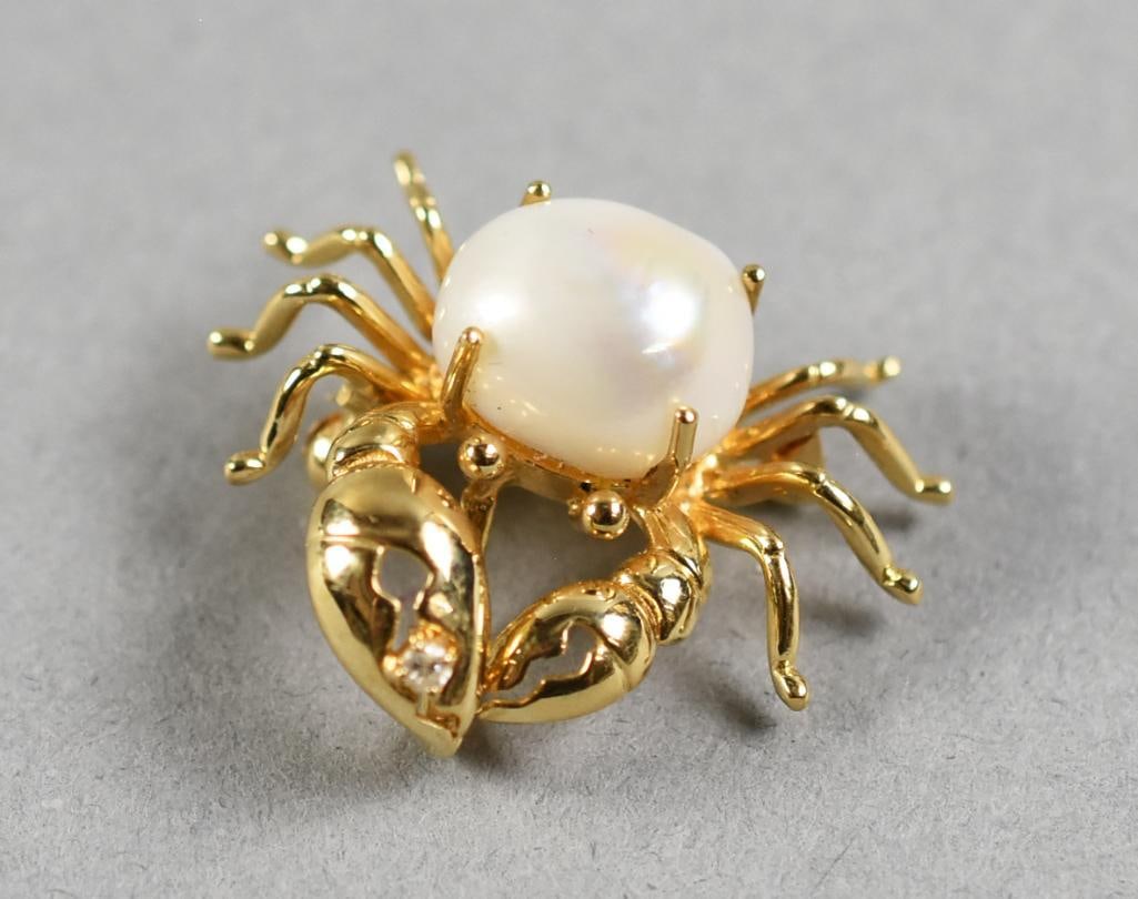 14K Gold Pearl & Diamond Crab Brooch: Adorable brooch in 14K yellow gold. It is in the form of a crab with a pretty pearl "shell" and a single round cut diamond in one claw. It is marked 14k and 585, unidentified designer mark. Measures a