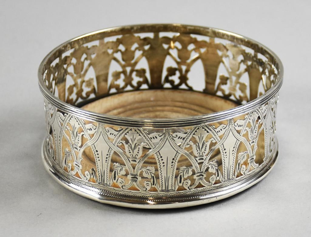 George Nathan, Ridley Hayes Birmingham Sterling Wine Coaster: This stunning piece is from London and Birmingham silversmiths George Nathan and Ridley Hayes, trading under the name Nathan & Hayes. Sterling silver wine bottle coaster, reticulated in ornate details