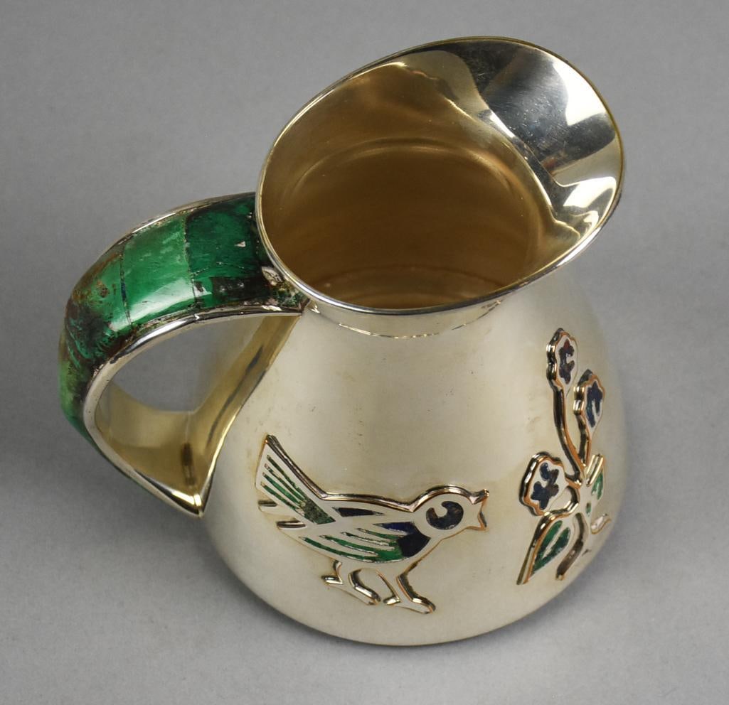 Los Castillo Taxco Mexico Silver & Malachite Inlay Pitcher: This is an adorable silver plate pitcher from Los Castillo, Taxco Mexico. Raised bird with flower on body, inlaid with stone and malachite inlay covers the handle. The mark on the bottom is a bit diff