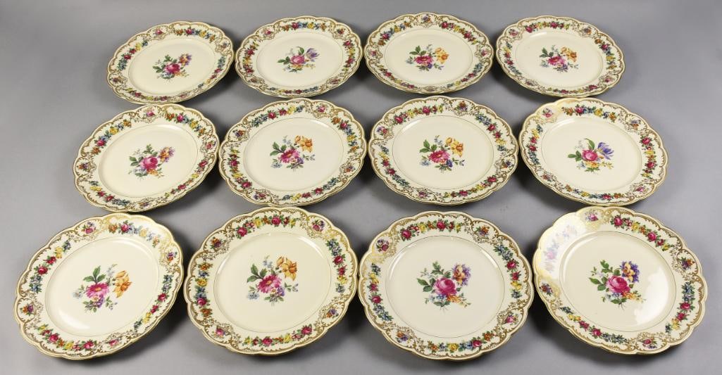 Royal Bayreuth Nurenberg Porcelain Dinner Plates: This is a set of 12 dinner plates from Royal Bayreuth. The pattern is called Nurenberg, scalloped rims with flowers and gold gilt details and center floral spray. Each measures approx. 10 1/4" across.