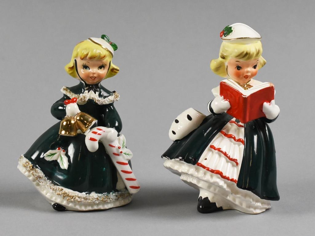 c1950 Napco, Relco Christmas Girl Porcelain Figurines: Precious little figurines of little girls at Christmas time. The first little girl is Relco?Japan wearing a green dress holding a candy cane, retains original gold foil label, the second, also wearing
