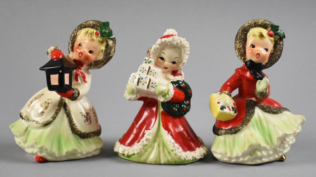 c1950 Napco Christmas Girl Porcelain Figurines: Darling variety of vintage Napco figurines. Two appear to be carolers one with a lantern, one appears to be holding a basket and a single girl with gifts in her hand. The two carolers retain their ori