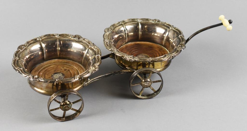 Victorian Sheffield Plate Decanter Wine Trolley: Awesome antique decanter or wine trolley. Each coaster with scallop and shell detail around the rim and attached to a frame with wheels and handle with what appears to be natural materials. No visible