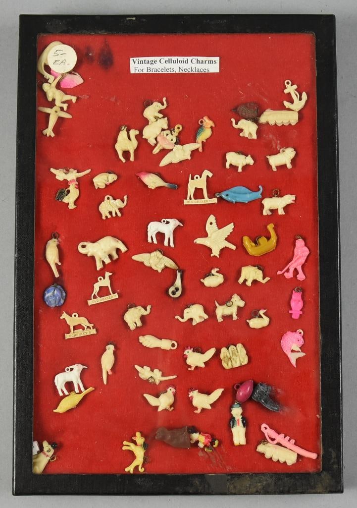 Vintage Celluloid Charm Collection in Riker: This is a cool collection of vintage celluloid charms in a riker. Nice assortment with few duplicates. Chickens, dogs, shoes, birds, elephants and more. Riker included.