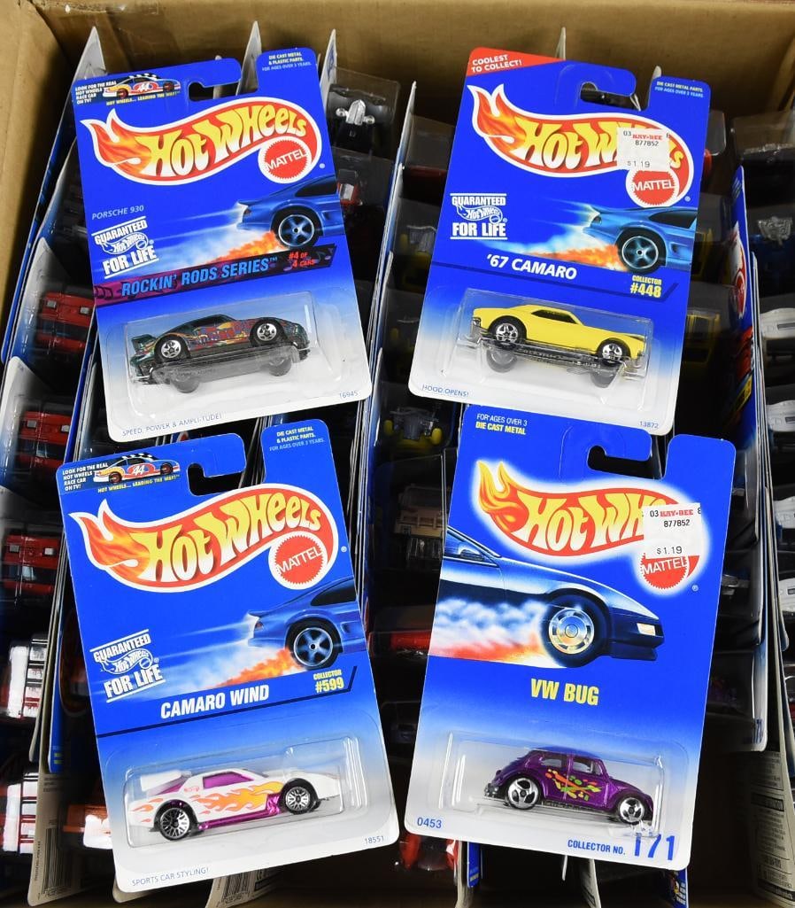 71 1990s Mattel Hot Wheels Factory Shipping Box MIB-NOS: Lot is 71 This collection includes multiple Hot Wheels cars still encased in their original packaging. Featured in this lot are models like the '67 Camaro, Camaro Wind, VW Bug, and models from the Roc