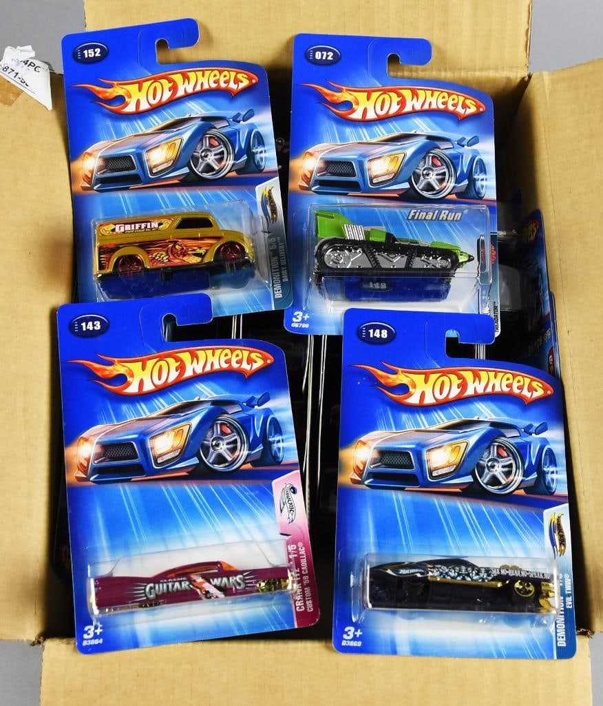 72 2000s Mattel Hot Wheels Die-Cast Factory Case MOC-NOS: This listing shows a sample of sealed lot of five Hot Wheels die-cast vehicles, all in their original packaging. Each car comes from different series, including notable designs such as 'Guitar Wars,'