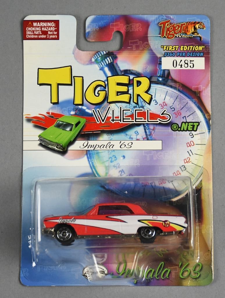 LTD. ED. Tiger Wheels Impala '63 (485/3360) Diecast Model: This limited-edition Tiger Wheels Impala '63 diecast model is labeled 485 out of 3,360, marking it as part of a small production run. The collectible is presented in its original package, featuring th