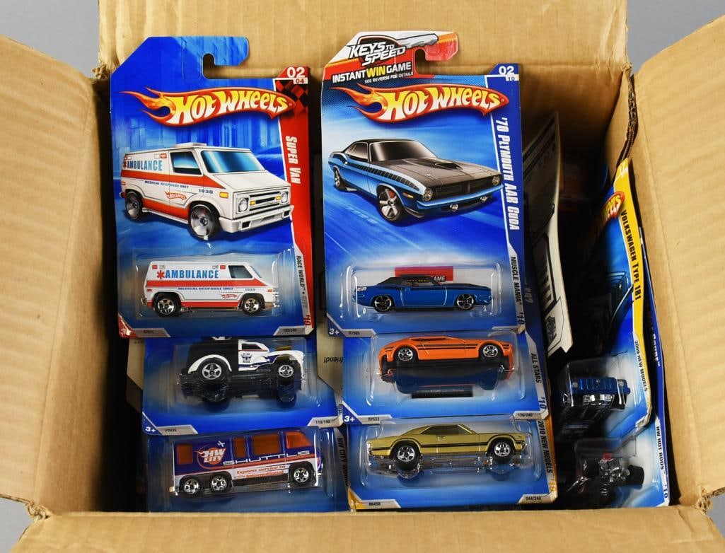 37 2000s Mattel Hot Wheels Assortment Factory Case-MOC-NOS: Counted 37, This lot features a collection of sealed Hot Wheels vehicles, each in its original factory packaging. The collection includes various models such as an ambulance and muscle cars from iconi
