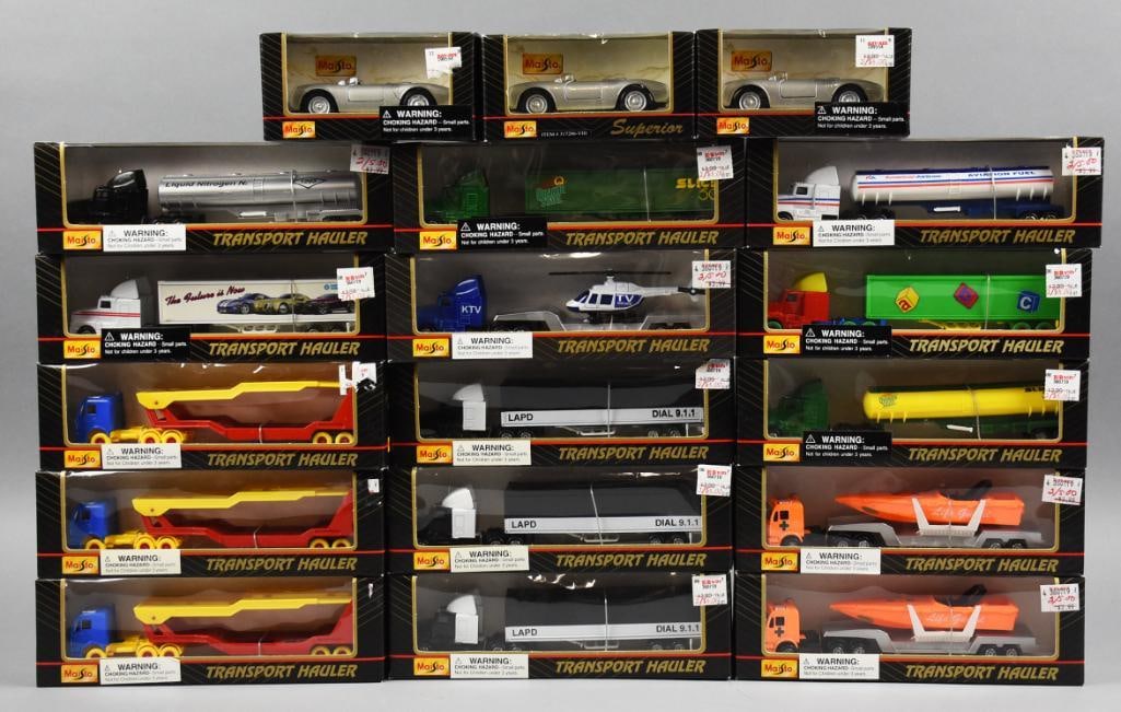 (18) Maisto Transport Haulers & Porsche Spyder MIB NOS: Lot is 18 Maisto Transport Haulers & Porsche Spyder-MIB-NOS. Haulers with boats, helicopters and more. Lot with duplicates. Single owner collection from the largest toy collector on the West Coast.
