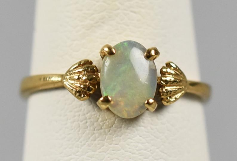 14k Gold & Opal Ladies Ring: Here is a beautiful and dainty ladies 14k yellow gold and prong set white opal ring. This ring is a size 5.5. Weight = 1.3g