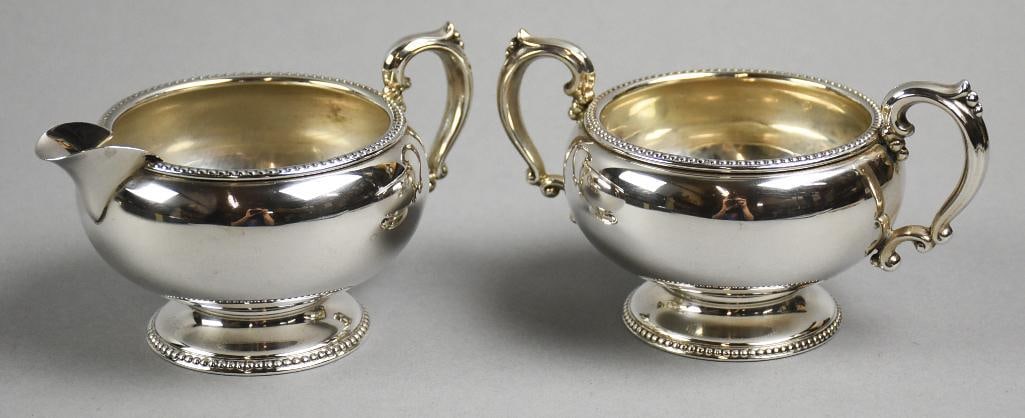 c1960 Fisher Sterling Silver Cream Pitcher & Sugar Bowl: Great sterling silver cream pitcher and sugar bowl from Fisher Silversmiths. They are simple and elegant with beaded trip on rim and base with ornate handles. They are approx. 3" tall x 5" wide with a