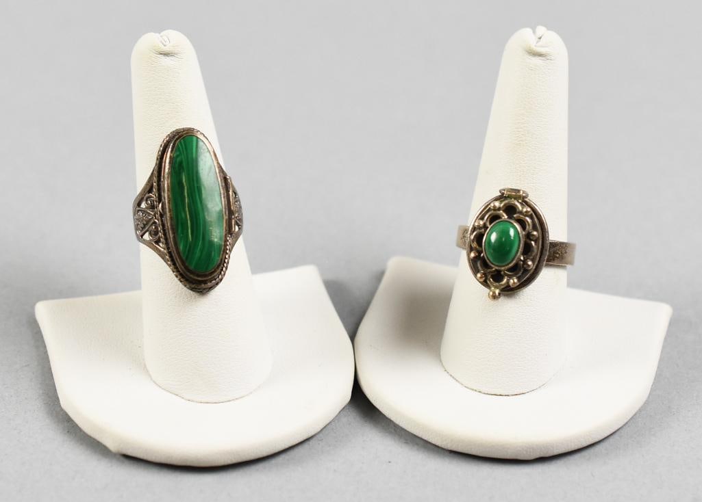 Vintage Sterling Silver & Malachite Poison Ring: Beautiful pair of sterling silver poison rings. Each ring with ornate lid and set with malachite. Both are stamped 925 and one with what appears to be a designer mark. They are sized approx. 8 and 9.