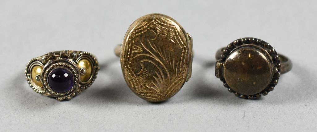 Poison Rings Vintage Sterling & Semi Precious Stone: Very pretty assortment of vintage sterling poison rings. One with a cabochon amethyst and gold accents, one with Victorian style engravings and one with a smooth domed cover. Two with visible 925 stam