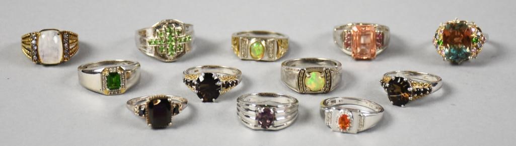 STS Sterling Silver and Semi Precious Stone Ring Assortment: This lot contains 12 different sterling rings marked STS. They are all bejeweled and appear to be opal, amethyst, peridot, topaz and more.?