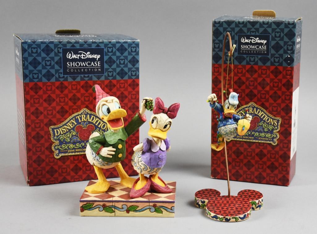 Disney Showcase Collection Donald Duck Figures Jim Shore MIB: This is a great pair of fun Disney Showcase Collection figures designed by Jim Shore and produced by Enesco. One is Donald and Daisy called "Mistletoe Moment" and the other is Donald with Lights on St