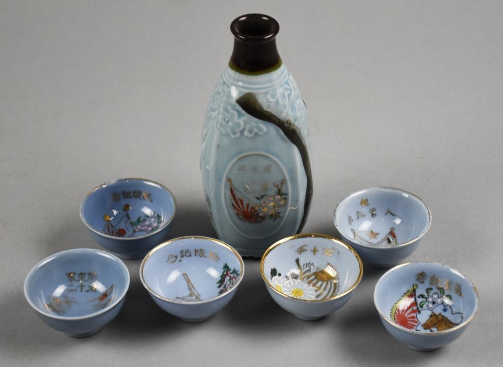 WWII Era Japanese Ceramic Commemorative Saki Set-Signed: Fantastic WWII era Japanese Commemorative saki set. They have a beautiful blue glaze, hand painted flag and flowers and gold calligraphy. There are six cups, each with a different theme, flags, horse,
