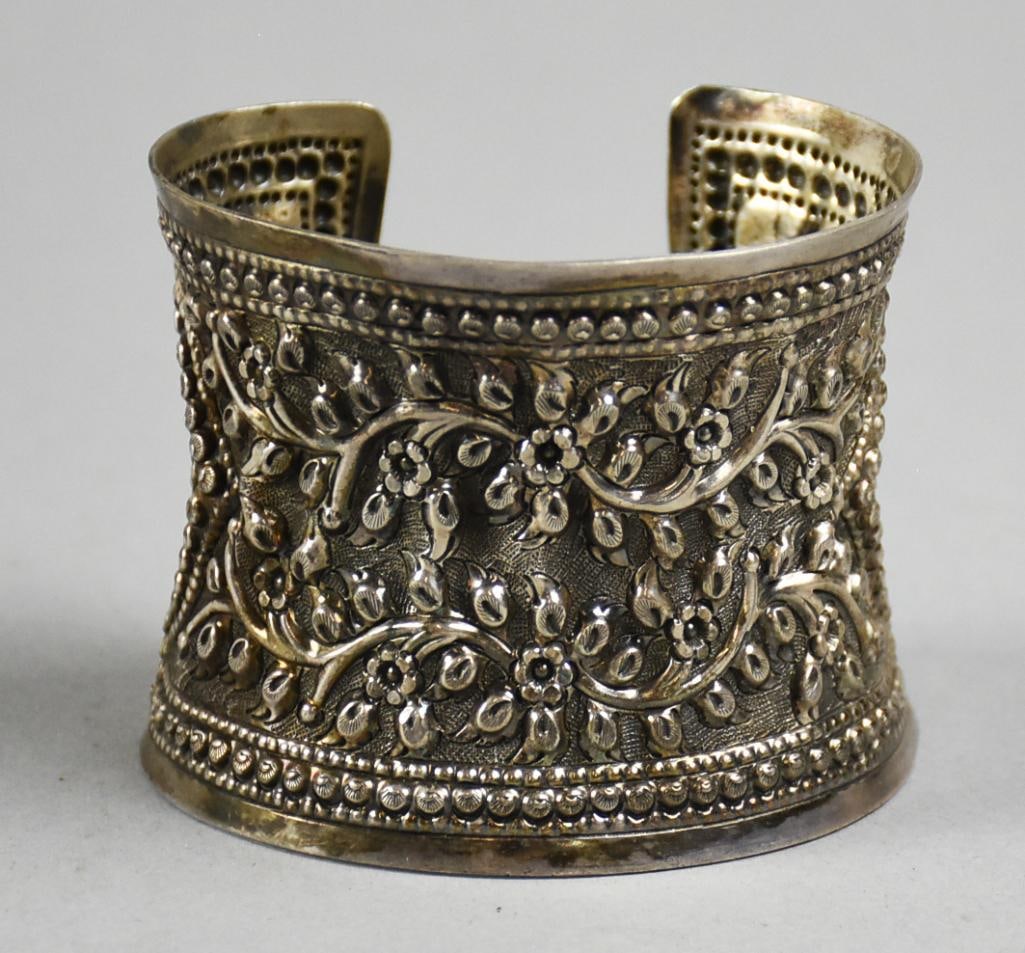 Sterling Repousse Wide Cuff Bracelet: Absolutely stunning vintage sterling bracelet. Wide cuff of repousse flowers and vines and a repousse shell border. Measures approx. 2.25", approx. weight of 72 grams and is stamped 925 with no other