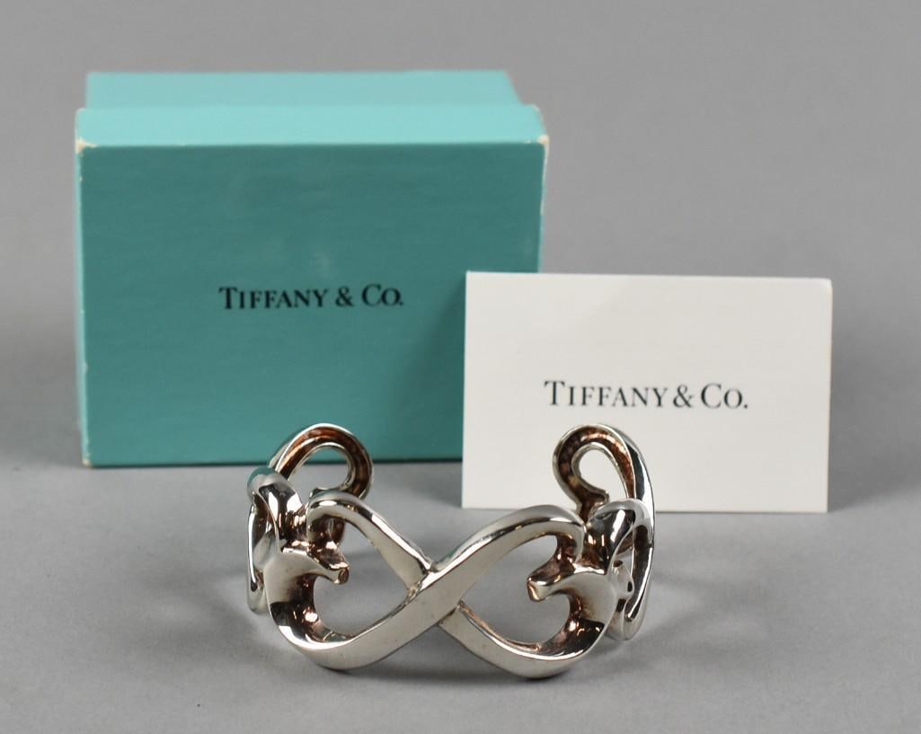 Tiffany & Co Sterling Paloma Picasso Loving Heart Cuff: Terrific sterling cuff bracelet from Tiffany & Co. It is known as the Loving Hearts. Sterling appears to be one piece with stylized hearts. Well marked inside and comes in the original box. Overall