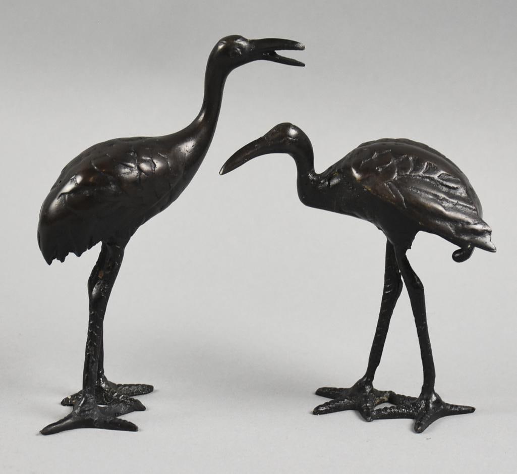 Vintage Japanese Bronze Heron Pair: These cute pieces are Japanese and appear bronze. These herons in two different poses would look great inside or out. No visible marks and stand approx. 5" and 6" tall.?These pieces were in a Japanese