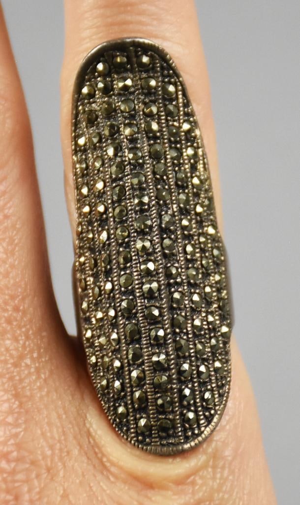 Vintage Sterling Silver & Marcasite Statement Ring: Gorgeous vintage statement ring in sterling silver. It is encrusted in marcasite and is approx. 2" long with as size approx. 9.5/