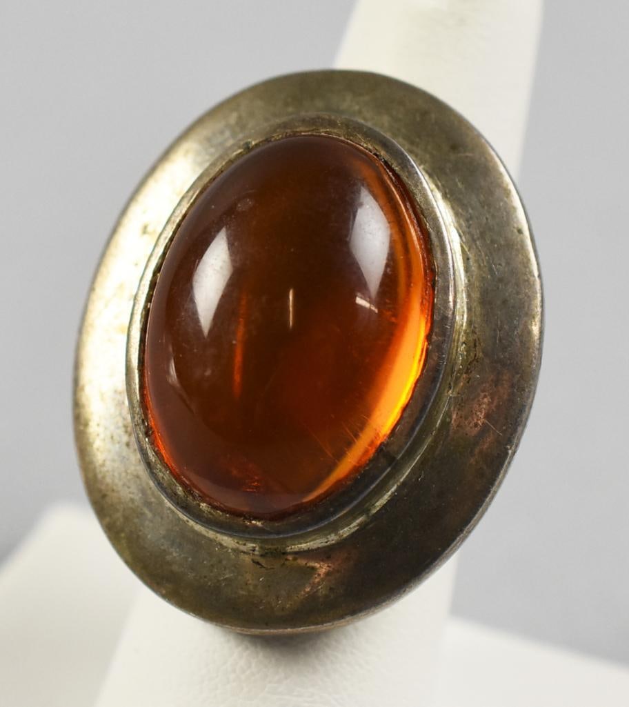Vintage Sterling and Amber Cabochon Ring: This very cool ring is sterling silver. It is set with a nice oval cabochon amber stone with inclusion. No visible marks, tests sterling and is an approx. size 7.