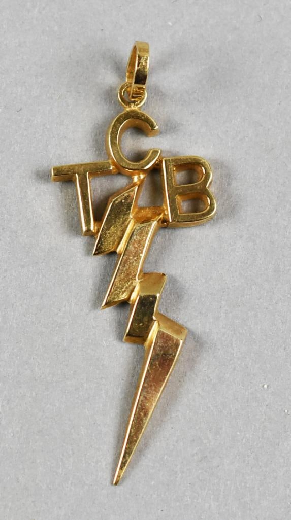 Elvis Presley 14K Replica TCB Lightning Bolt Charm: Very cool charm in 14K yellow gold. It is a replica of the Elvis Presley TCB (Taking Care of Business) with lightning bolt, The bale is stamped with the designer mark and 14K. Charm is approx. 1.5"