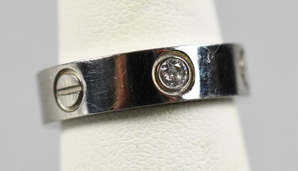 Cartier 18K White Gold and Diamond Love Ring: Very cool 18K white gold ring from Cartier. It has three diamonds alternating between what appears to be flat head screws. The edge of the band is marked LOVE, inside the band is marked with Cartier 7