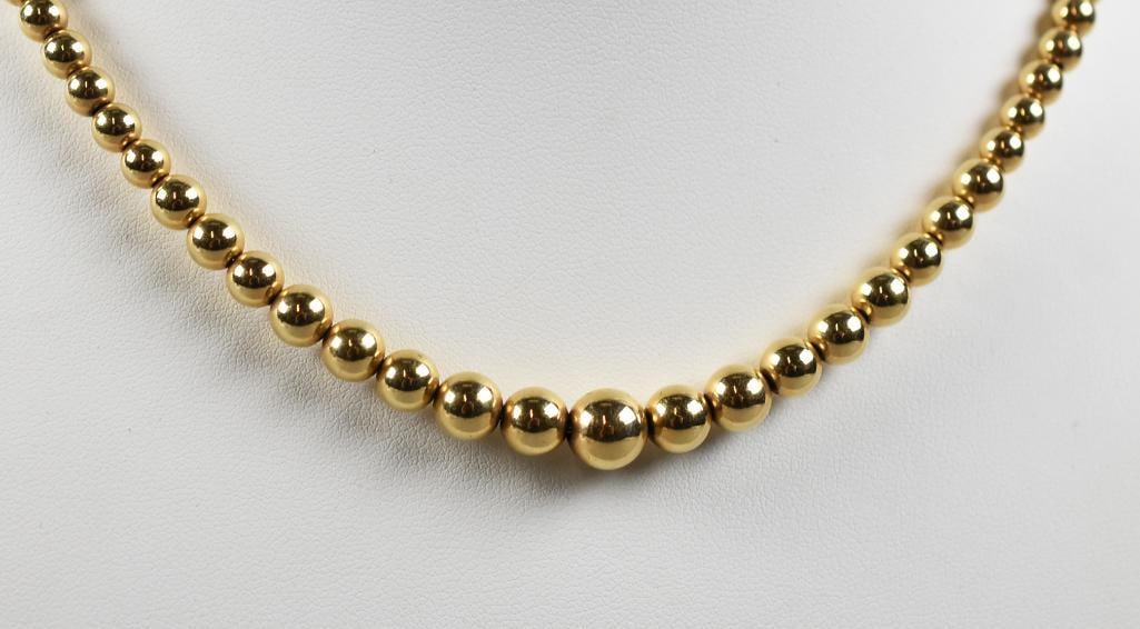 14K Yellow Gold Graduated Ball Bead Necklace: Very beautiful 14K yellow gold necklace. It is graduated ball beads. Stamped on clasp with an additional illegible mark. Overall approx. eight of 14.94 grams.